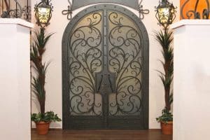 intricate iron and wood door design 