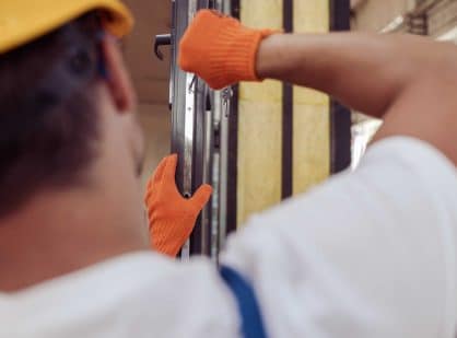 close up of professional installing iron doors